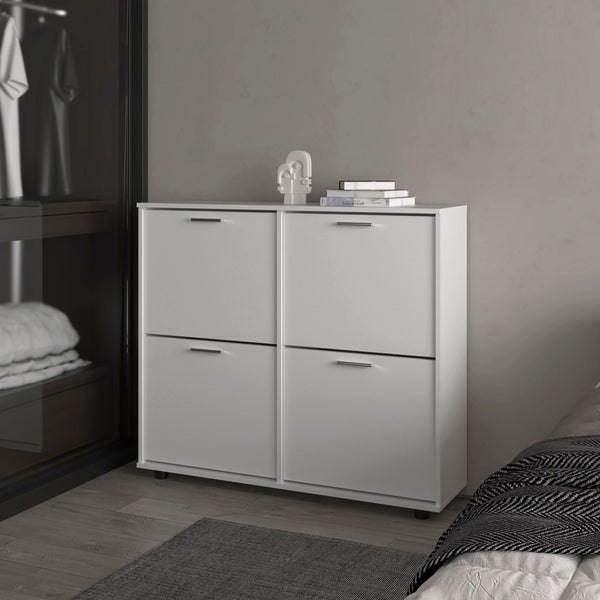 White double-door cabinet with four equal drawers, placed in bedroom
